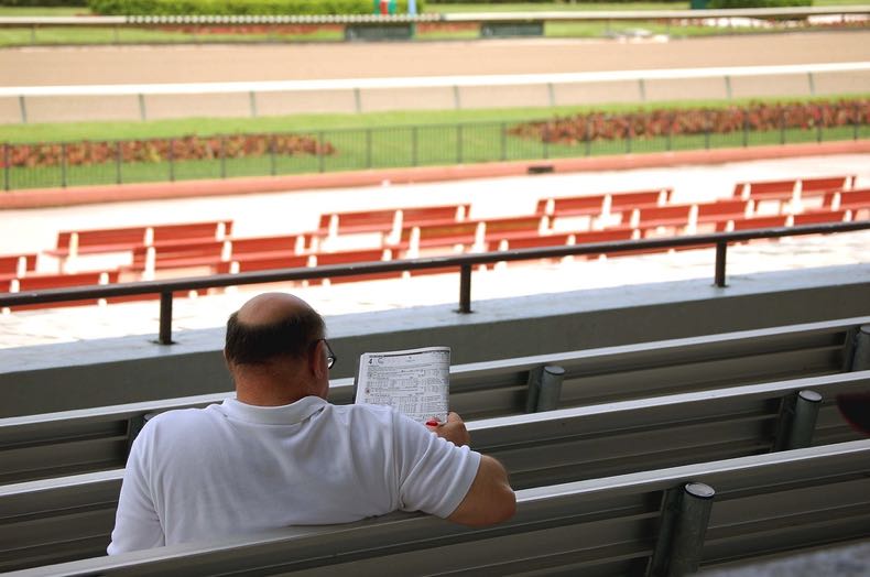 Man at the racetrack betting