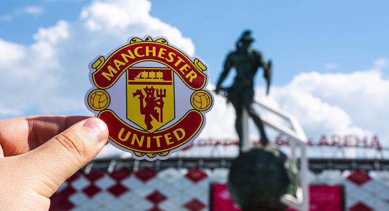 Manchester United logo with stadium